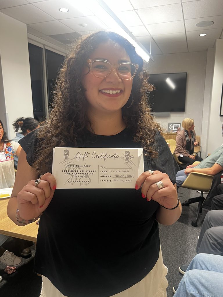 Emma Garcia, winner of one of two raffle items, holds gift certificate.