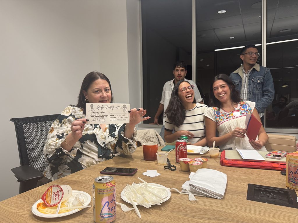 Maria Peña with a gift certificate raffle item.